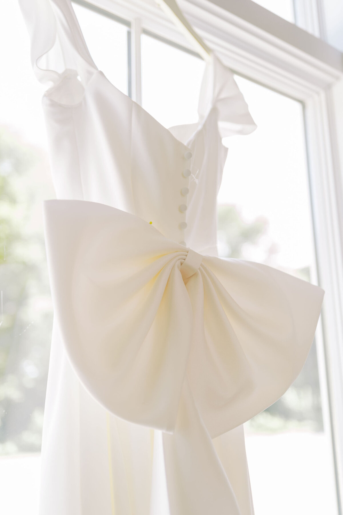 close up of the bow on a wedding dress