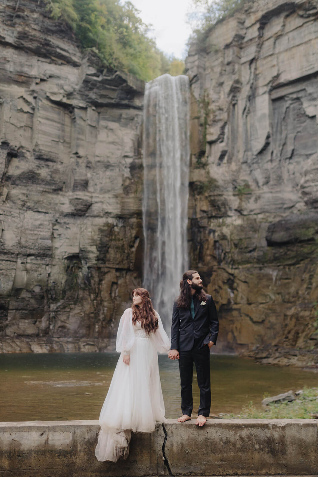 Bride and groom in front of waterfall at Finger Lakes wedding, NY