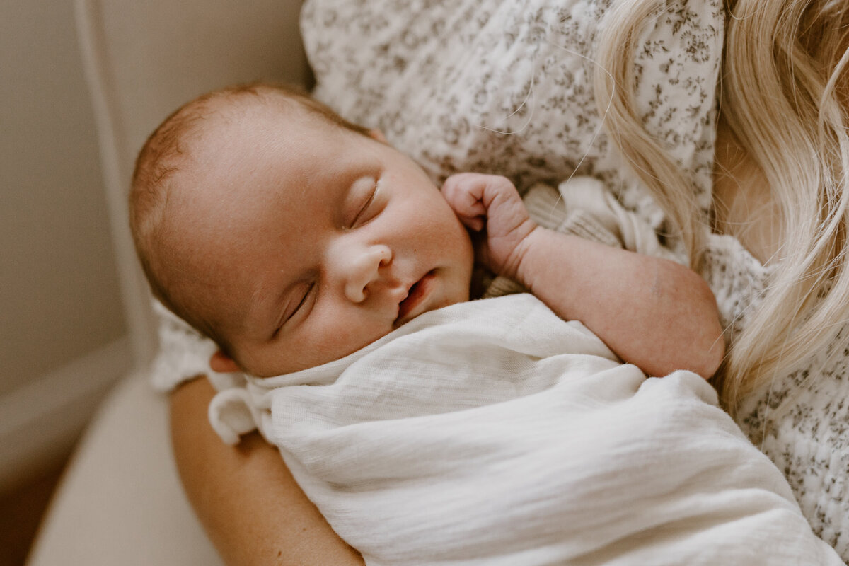 Newborn holding ear