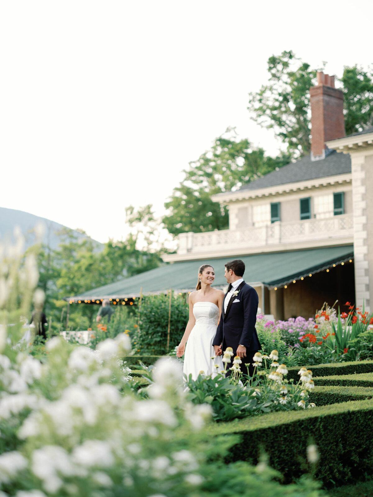 bride and groom walk through the gardens at hildene wedding in manchster, vt