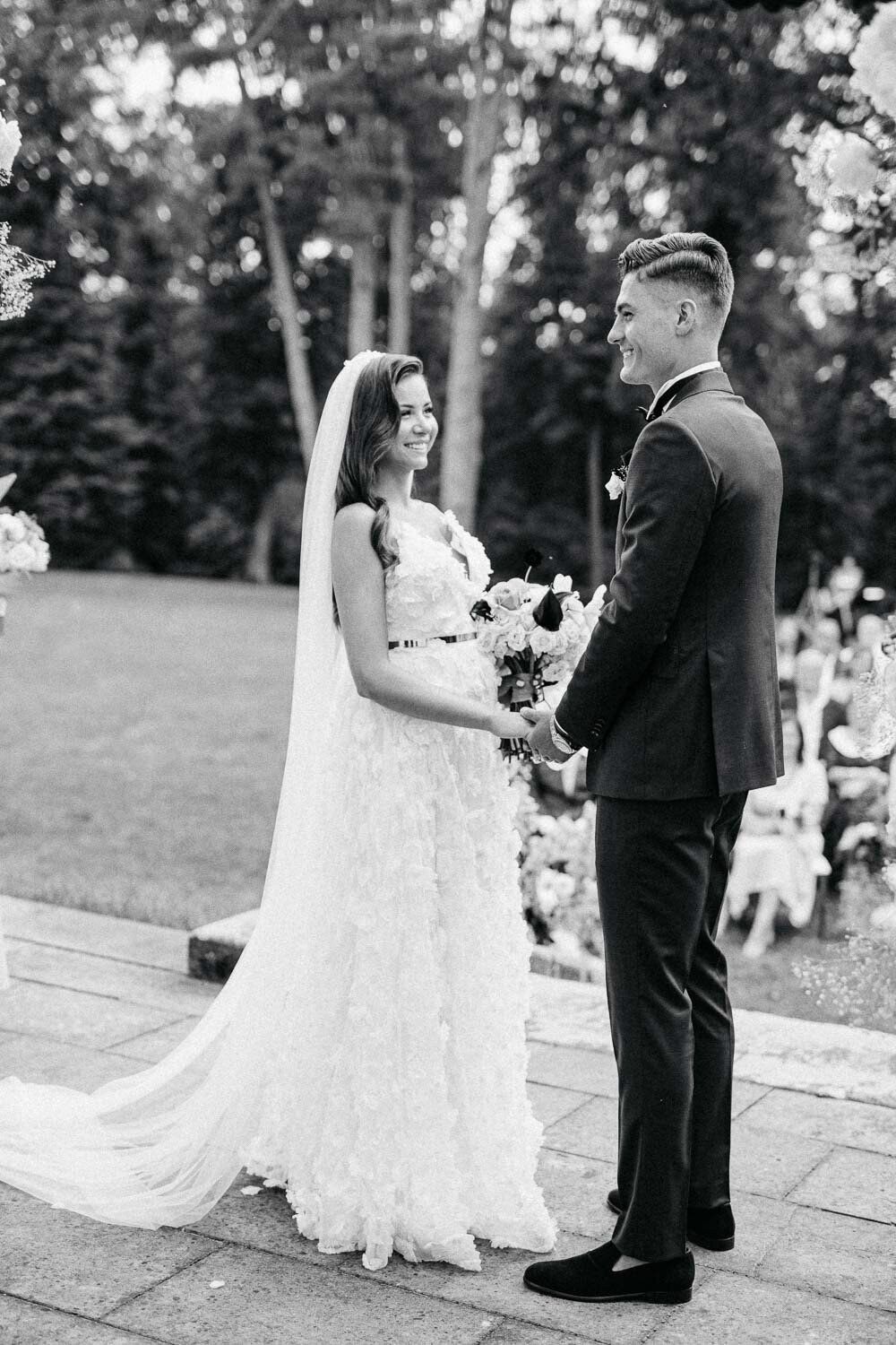 black and white ceremony moment with bride and groom