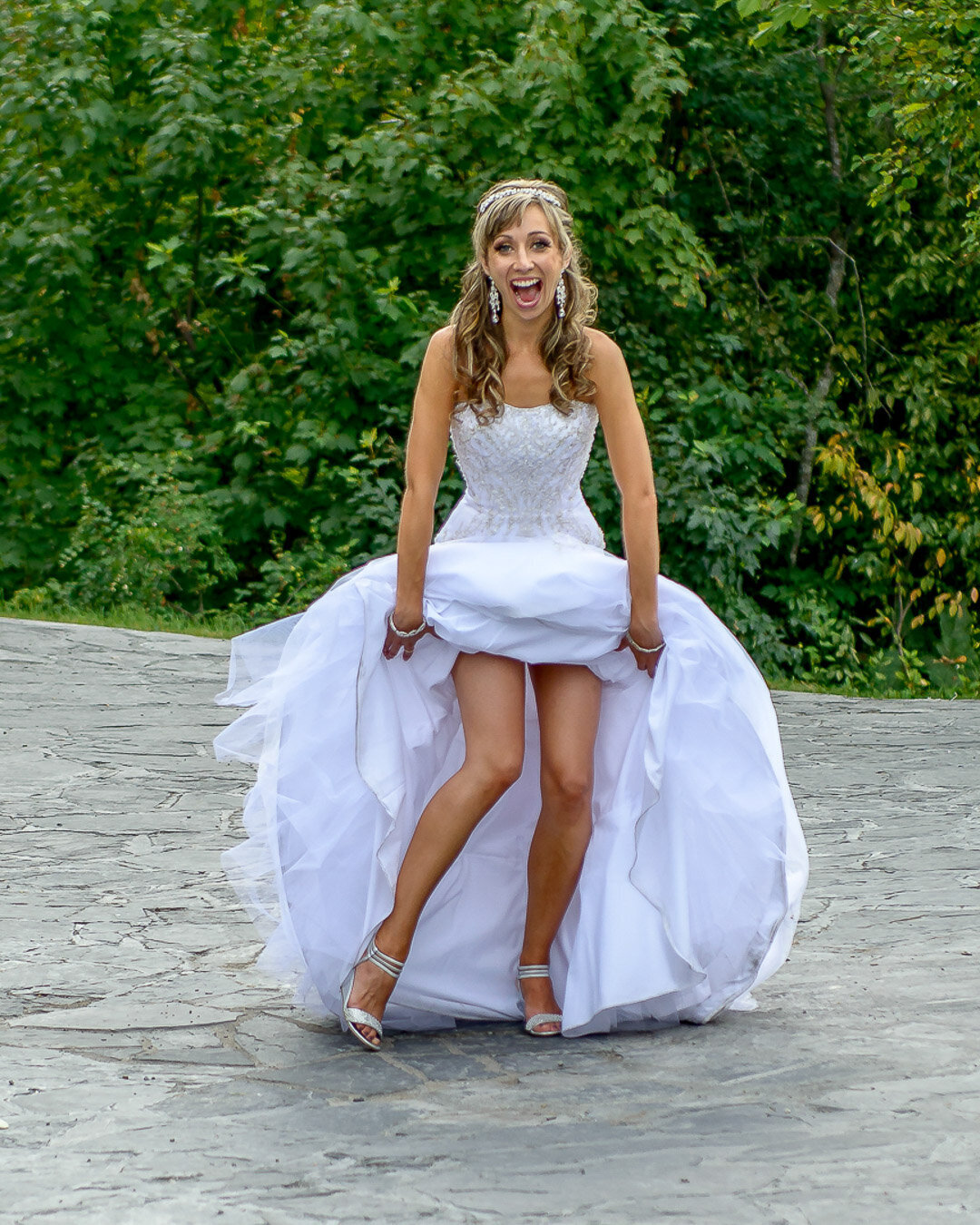 Bride hikes up wedding dress to expose legs and shoes