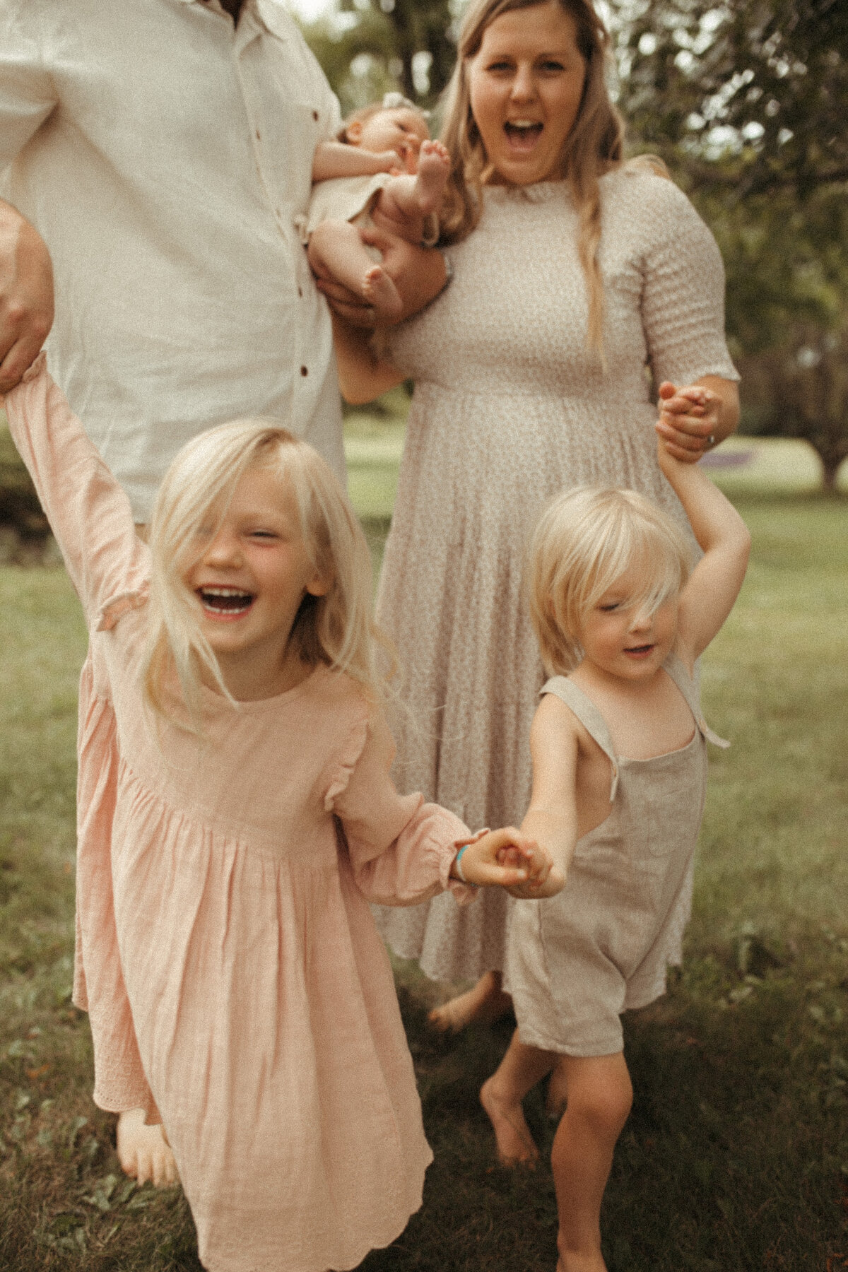 mother and father with children in field