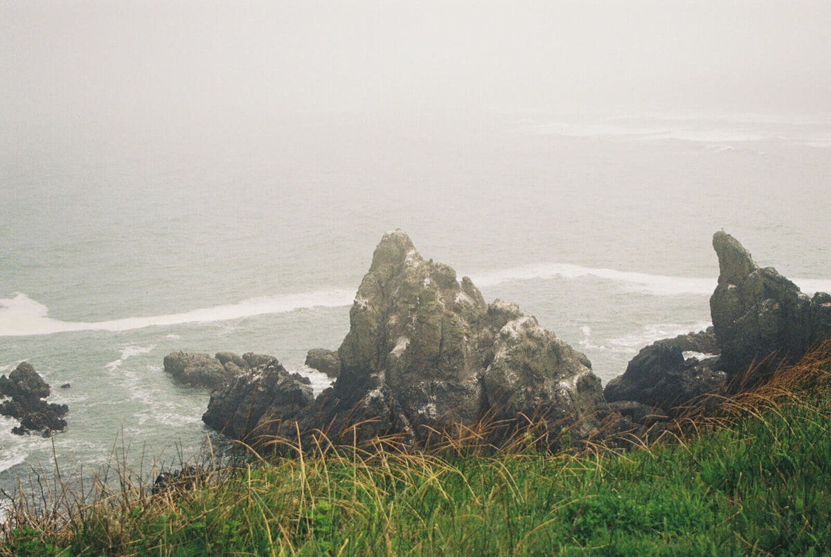 Rocky shoreline at the Oregon coast in the fog. 