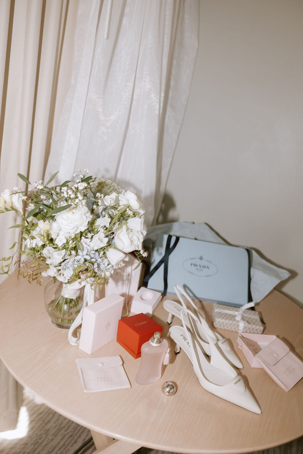 accessories and flowers on a tan wood table for bride getting ready in hawaii