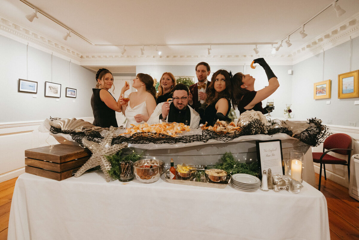 Wedding party enjoying shrimp at a seafood buffet station
