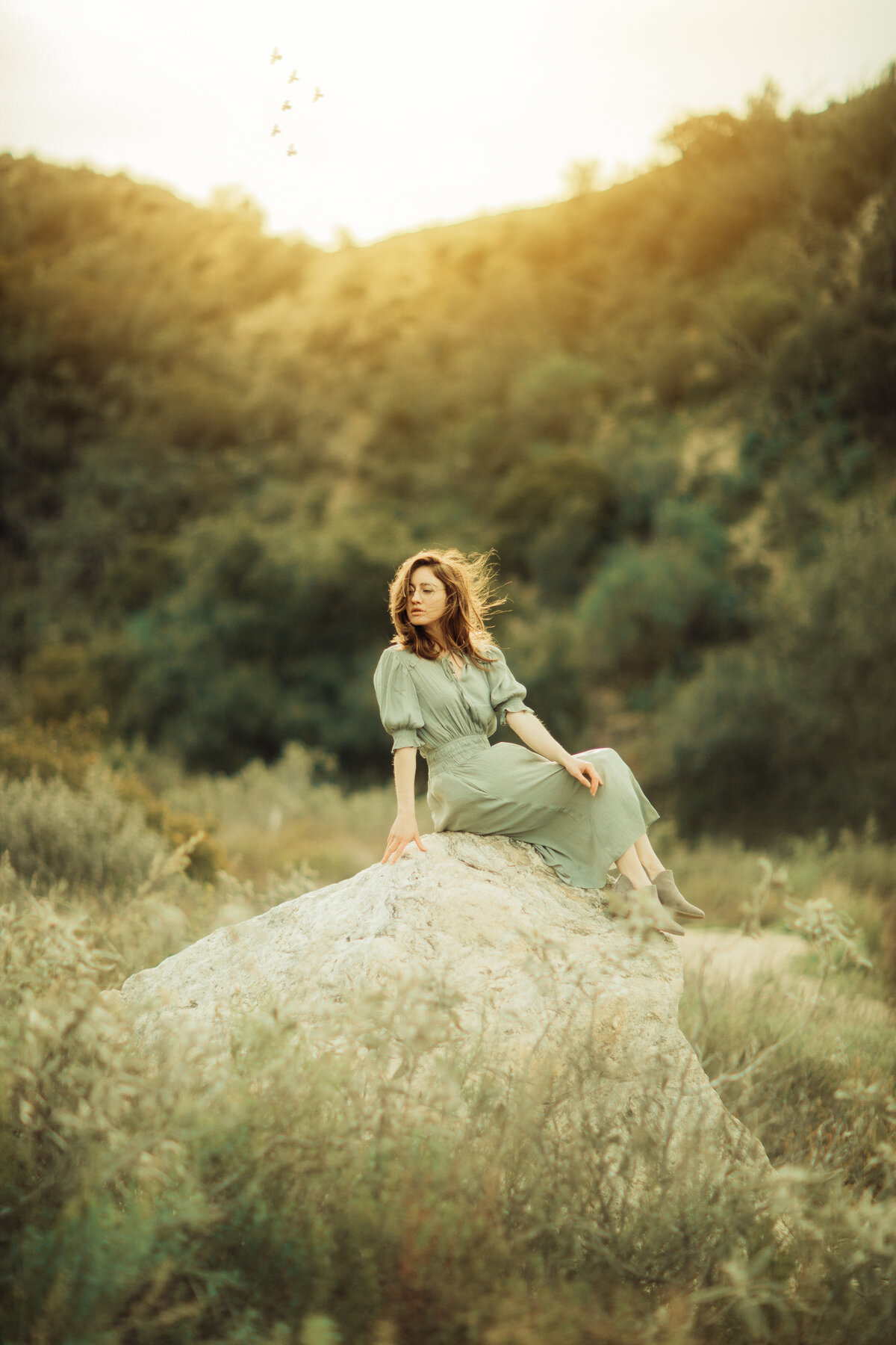 Portrait Photo Of Young Woman In Dress Sitting On a Rock Los Angeles