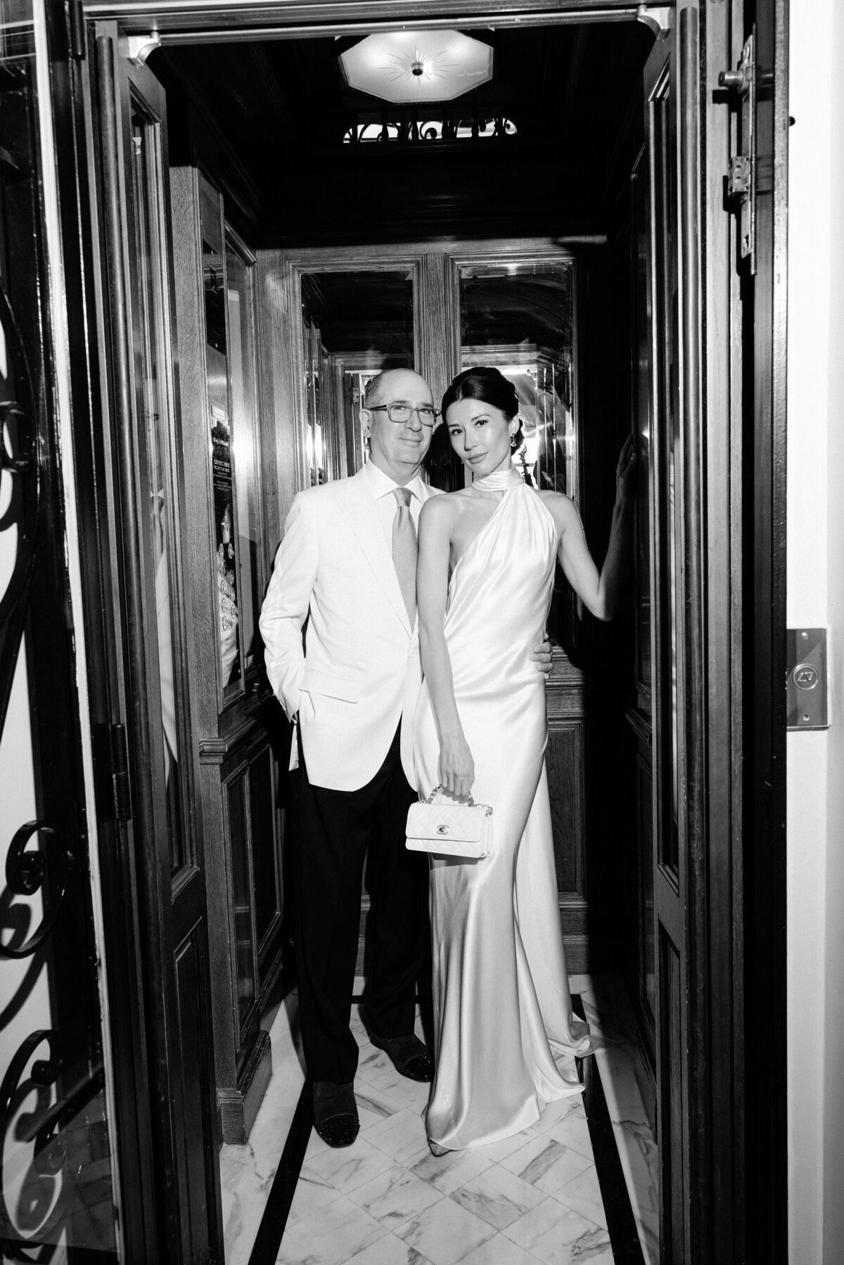 Elegant married couple posing in a lift of The Maybourne Riviera at Roquebrune-Cap-Martin, France