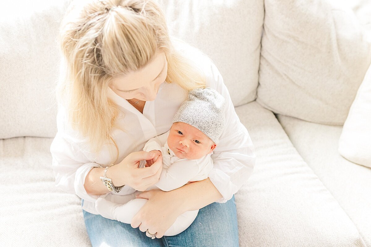 mom holds baby  during in home newborn photo session with Sara Sniderman Photography in Sherborn Massachusetts