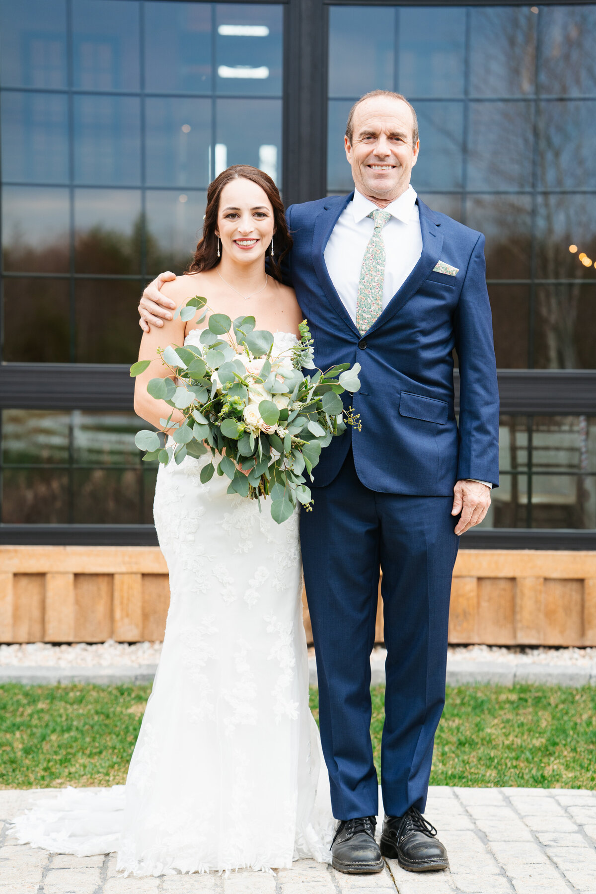 Bride and groom walking hand in hand at their outdoor New England wedding
