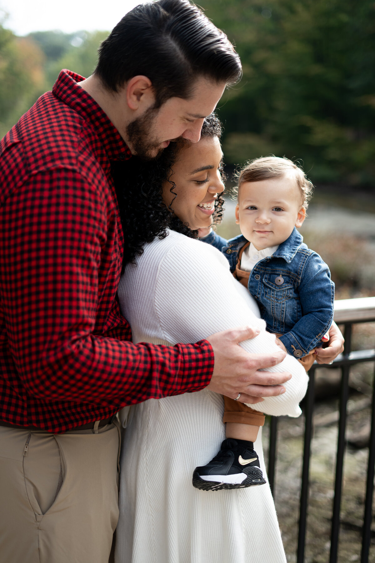 family smiling and snuggled up during fall family session near Cleveland