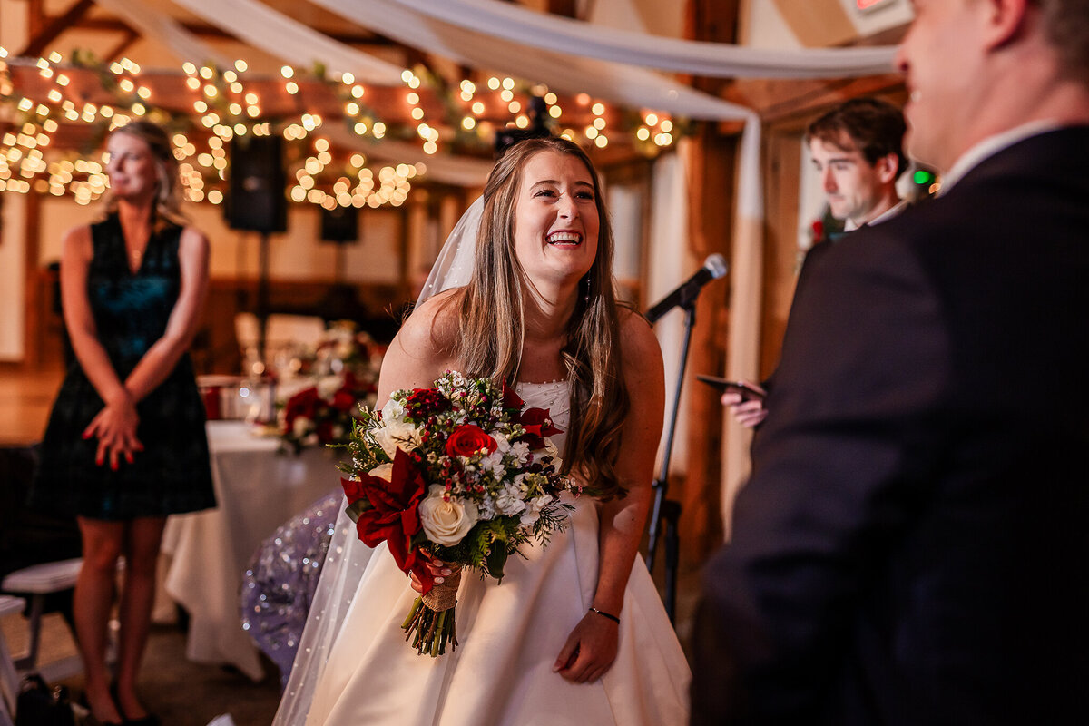 Bride laughing during ceremony by nh wedding photographer