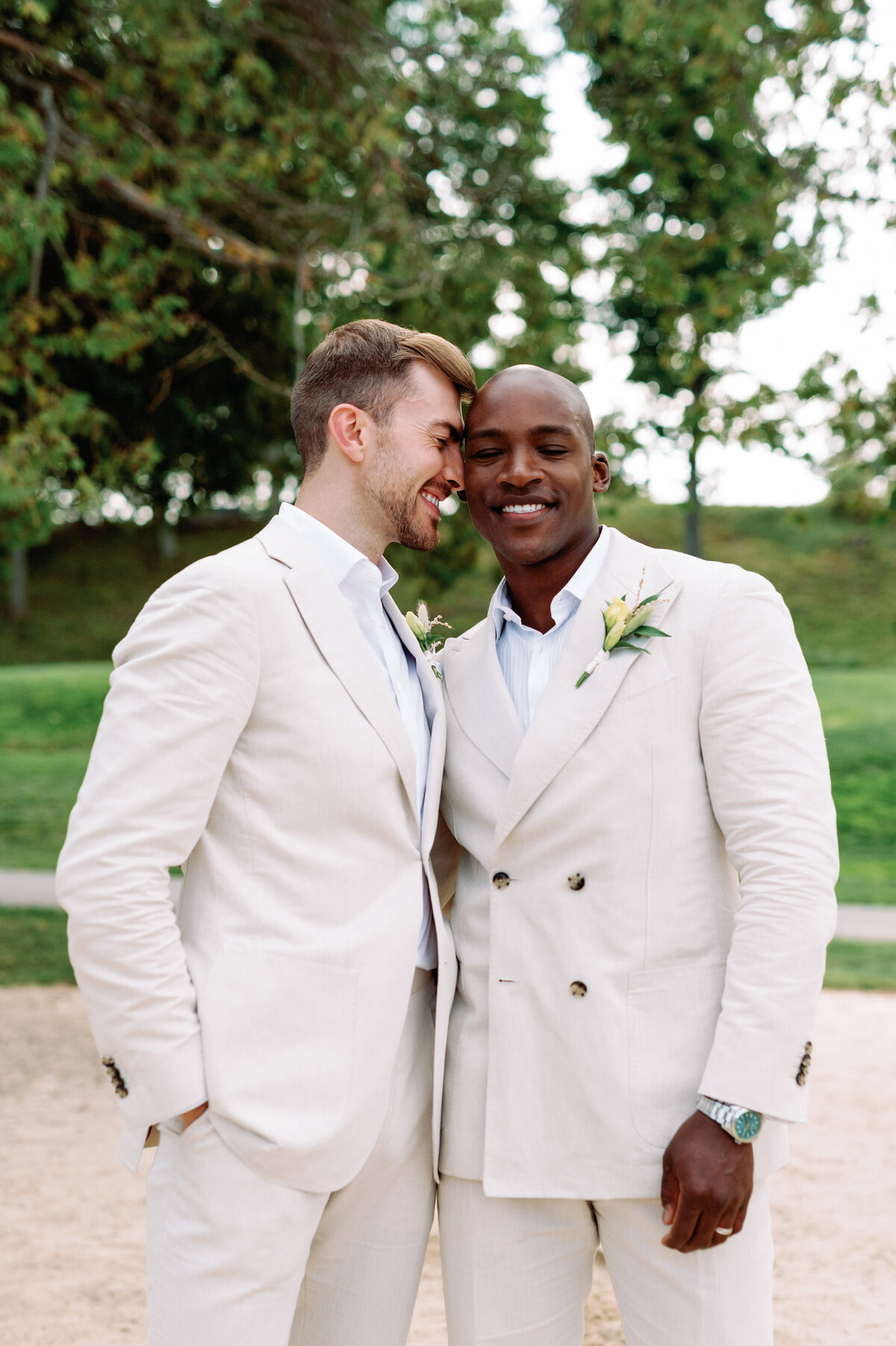 Gay couple sweet tender embrace on the beach Toronto wedding interracial