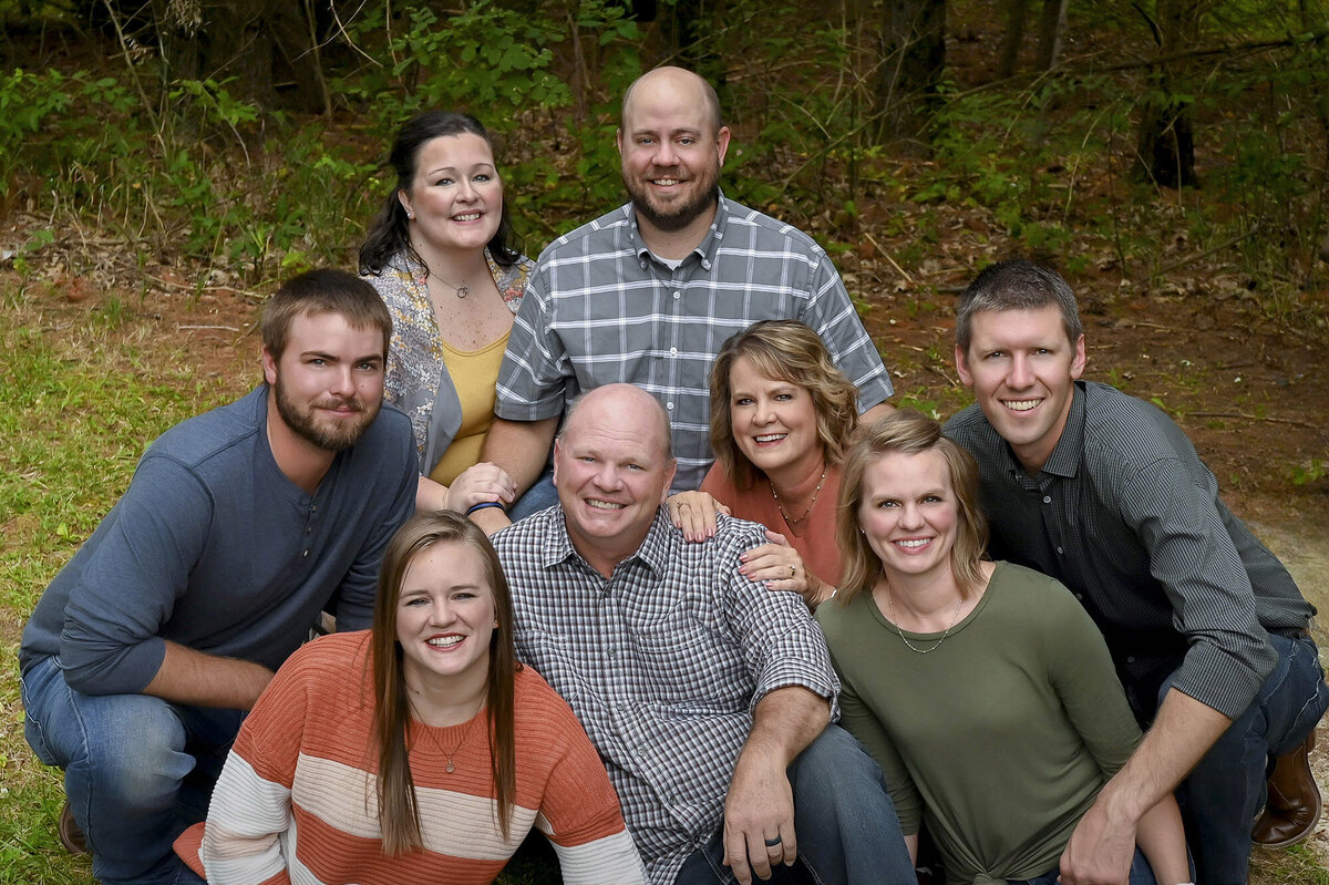 Adults sit together on the ground for Iowa Family Photos