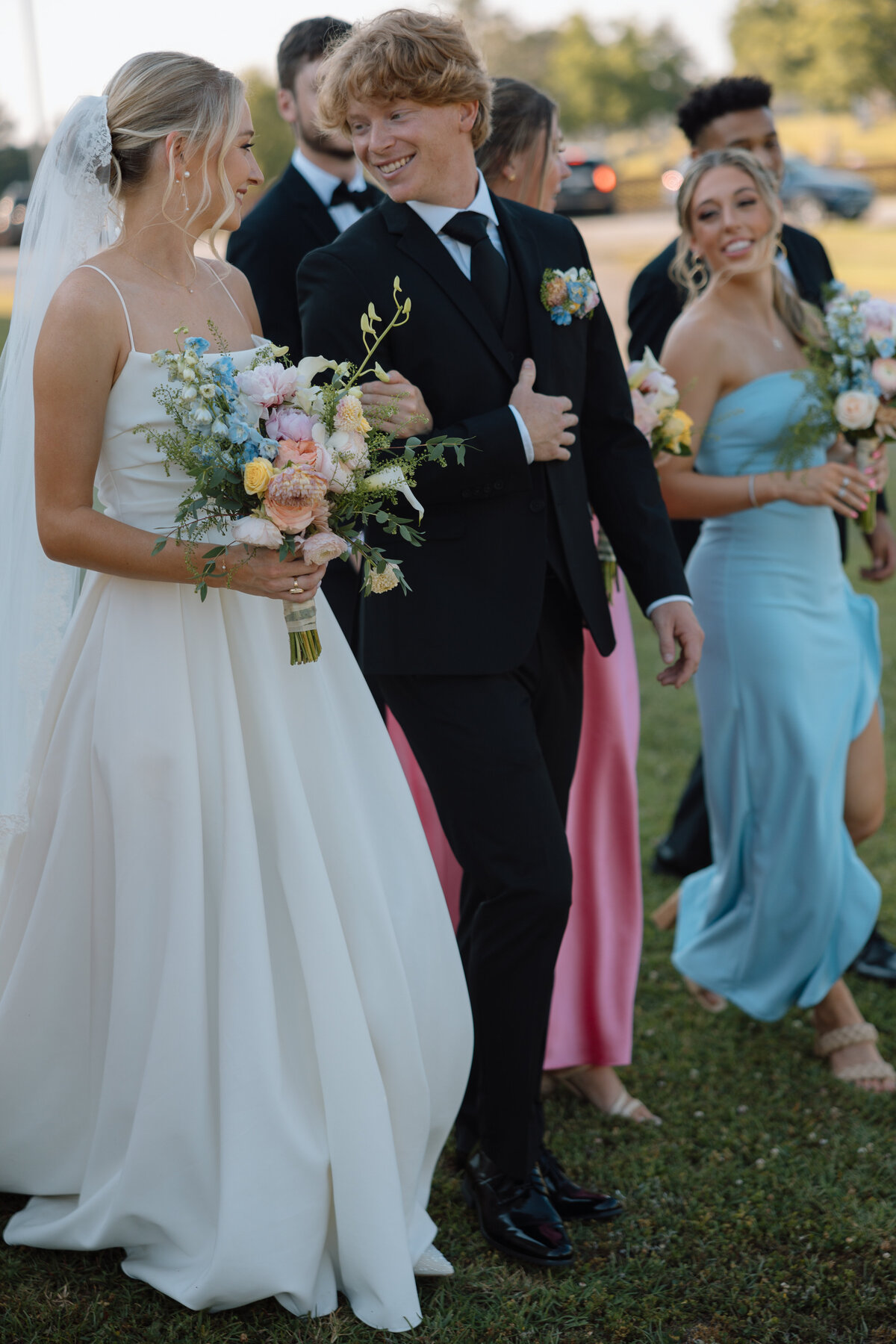 Bride and groom smile and laugh as they exit the ceremony