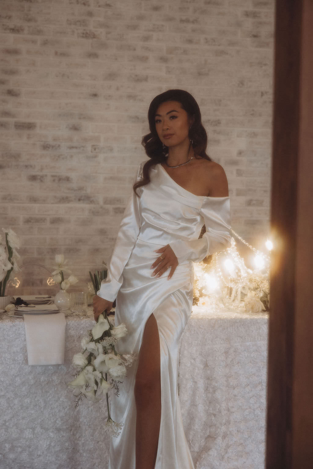 A person in a wedding dress holding a bouquet of flowers