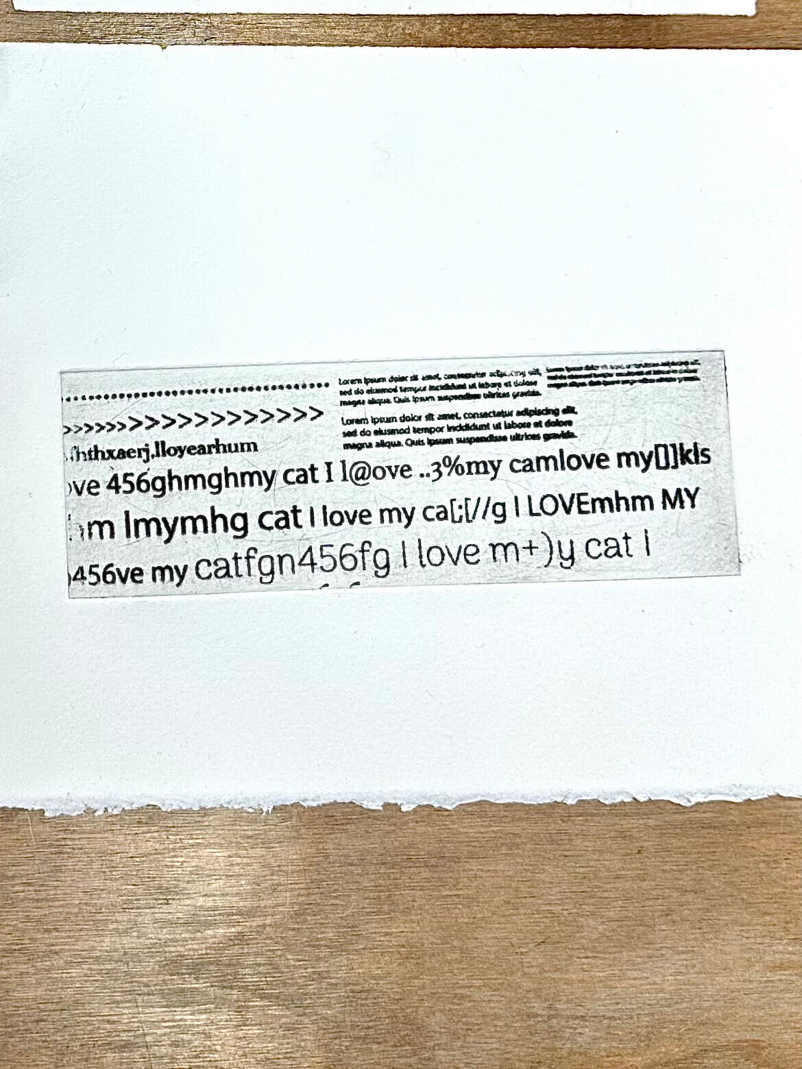 A print created with toner-transferred text and symbols, showcasing the experimental nature of the process.