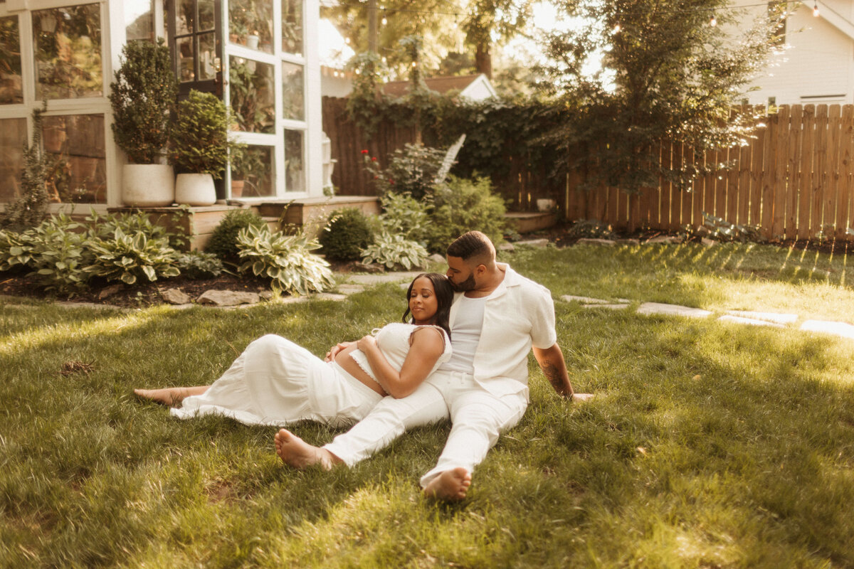Pregnant woman holding baby bump in open field during Franklin TN maternity photo session