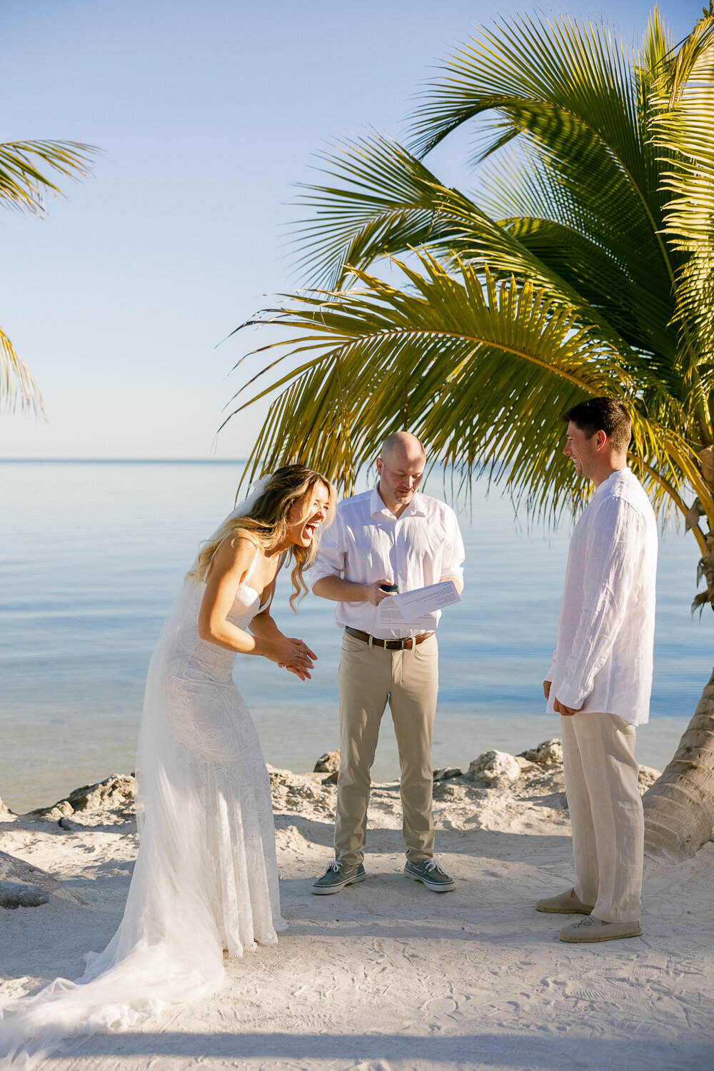  Laura and Abraham exchanging vows at their romantic beachfront wedding ceremony at Cheeca Lodge Resort.