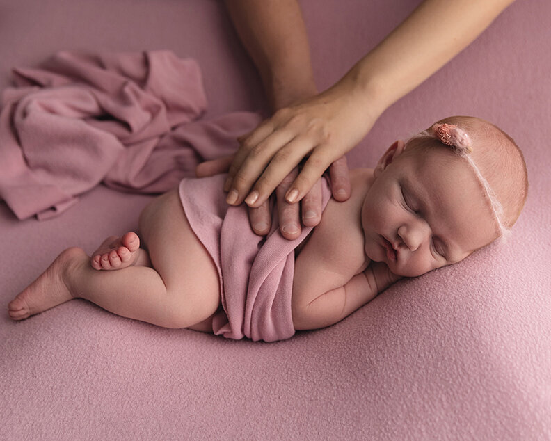 baby girl in pink with hands