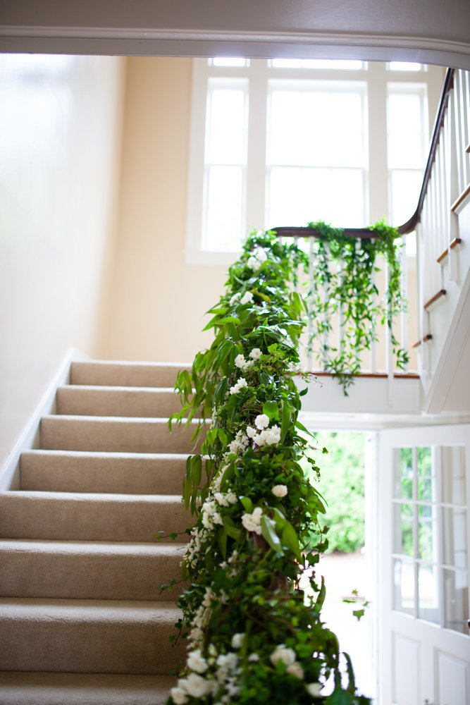 Romantic spring garden wedding floral staircase installation.