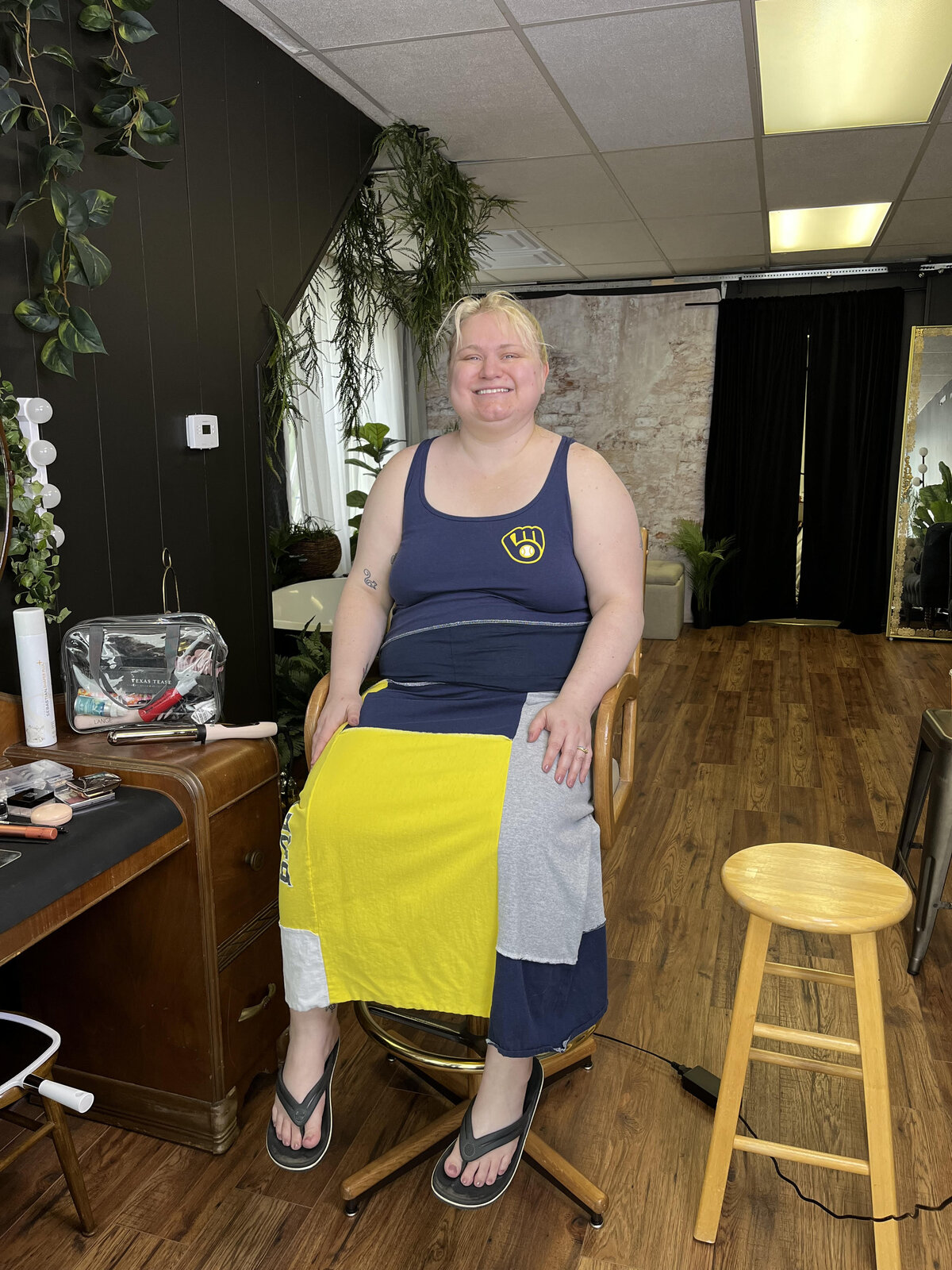a woman poses in a makeup chair