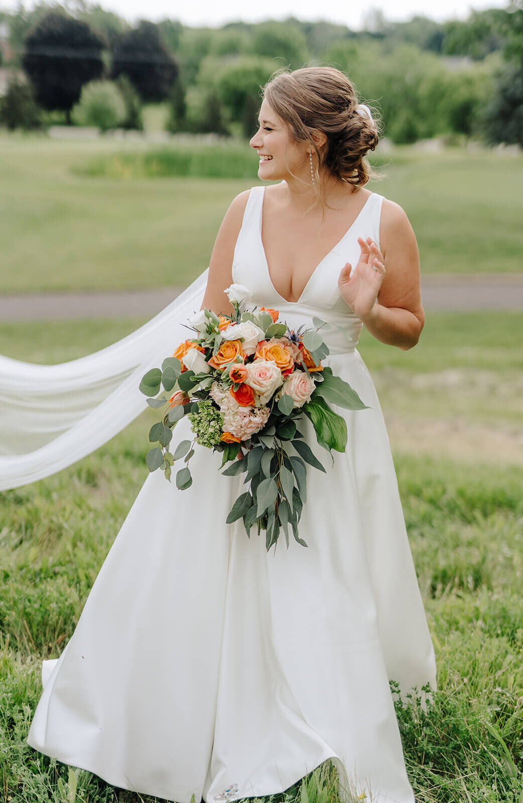 Bride holding colorful bouquet at Oswego wedding, NY