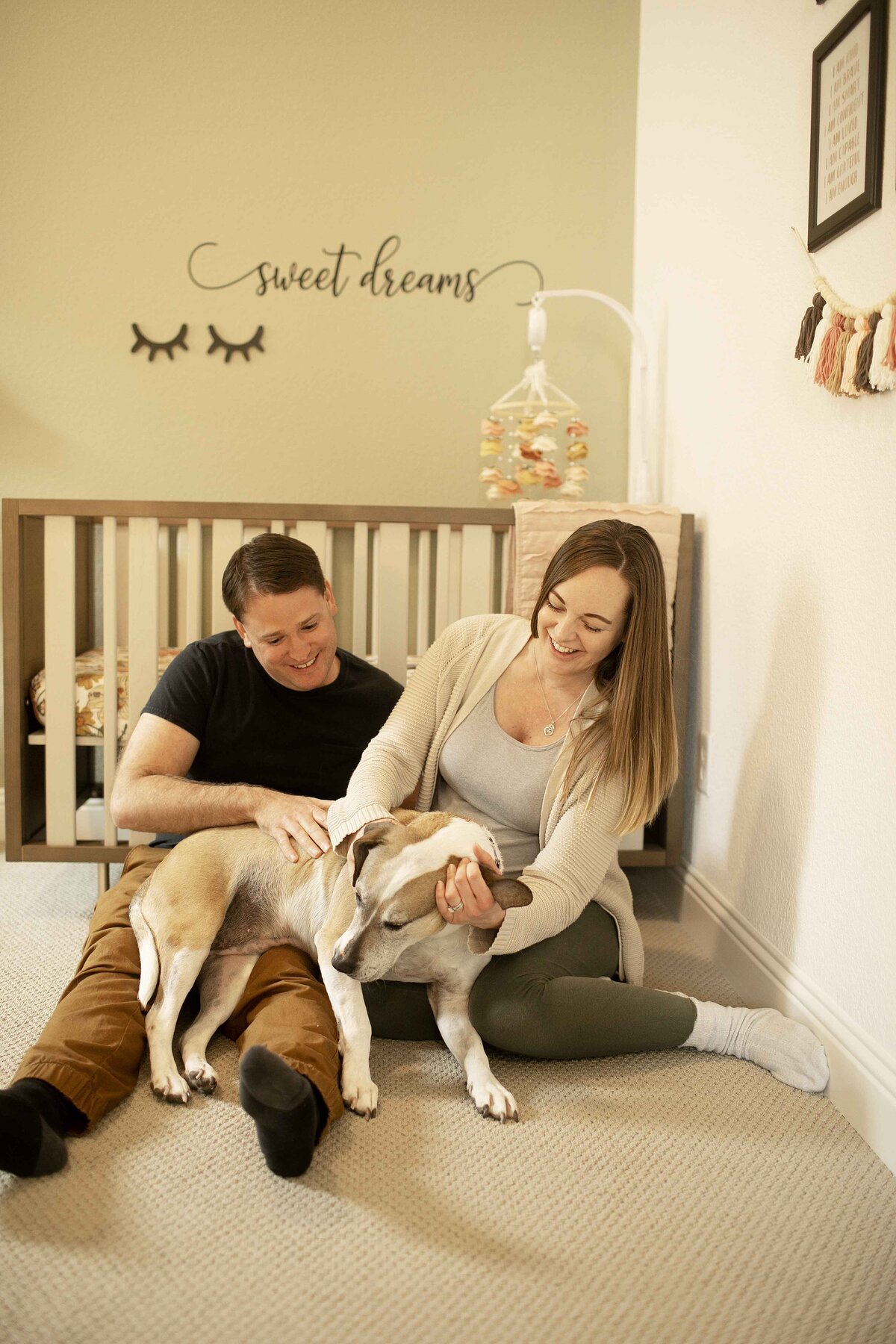 A heartwarming maternity portrait of mom in the nursery, softly holding her belly as she looks at the crib with love and anticipation for her baby’s arrival, captured by Chunky Monkey Photography.