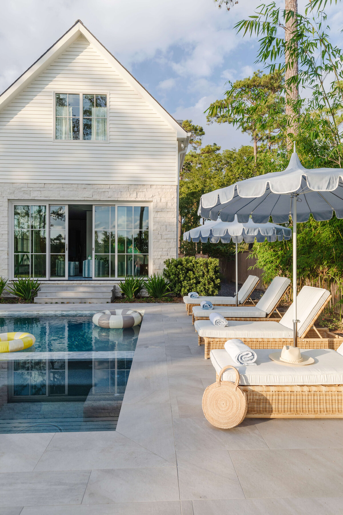 oyster creek studios memorial new build pool area with inground pool lounging area and umbrella