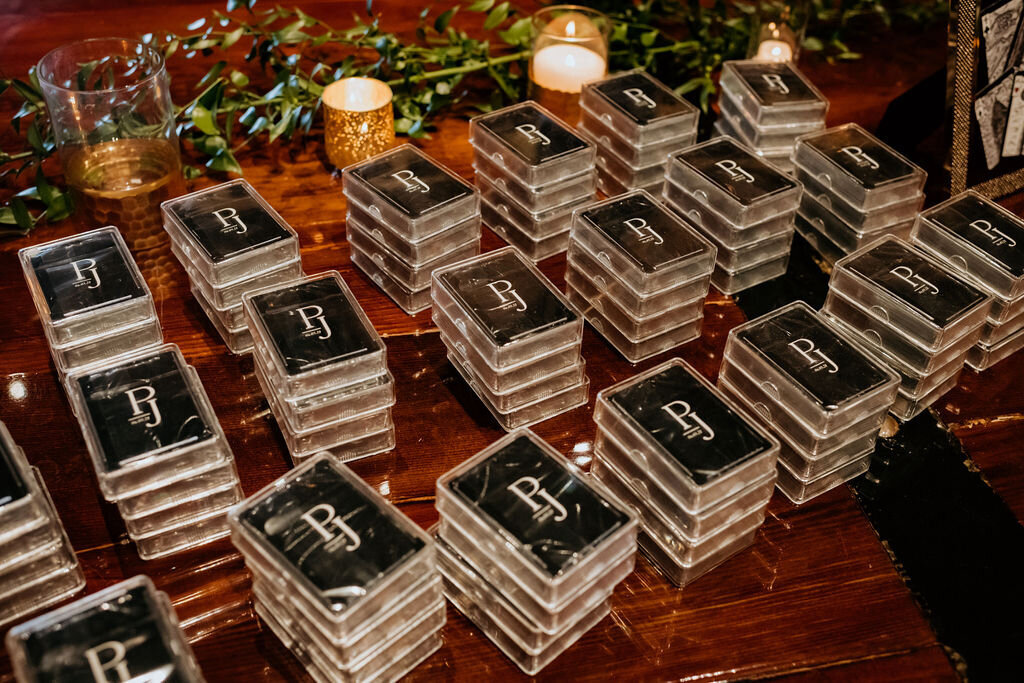 Custom black playing cards with a gold monogram as wedding favors for a spring wedding at the Palm Event Center in Pleasanton, CA.