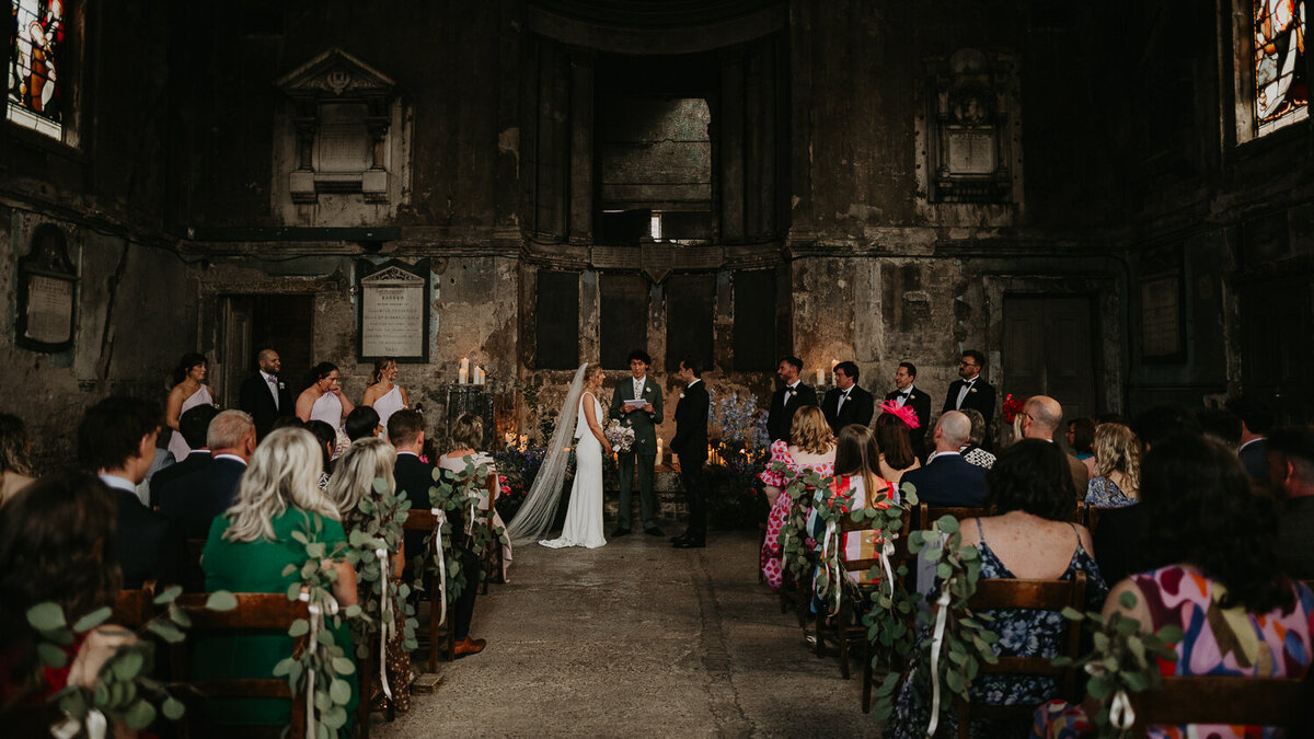 Wide shot of a bride and groom getting married at The Asylum Chapel in London. 