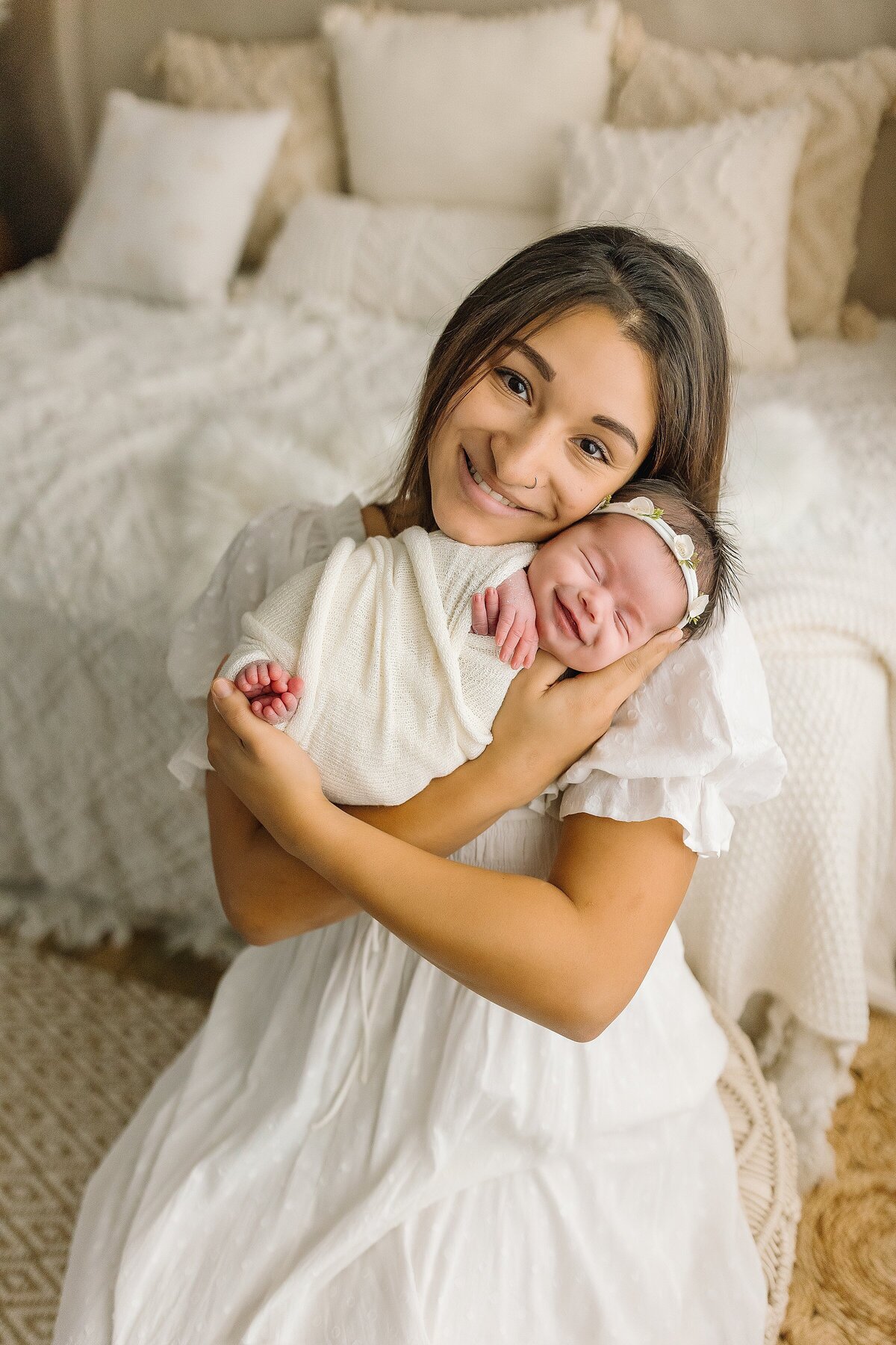 mom smiling with newborn girl in studio Harrisonburg VA