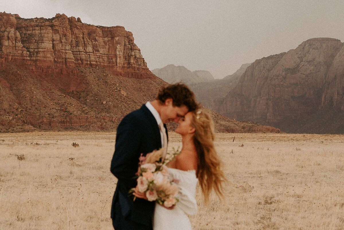 intimate ceremony on an open field overlooking Zions canyons