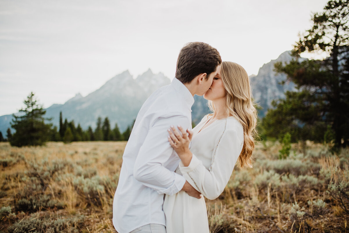 Photographers Jackson Hole capture couple kissing in front of Tetons