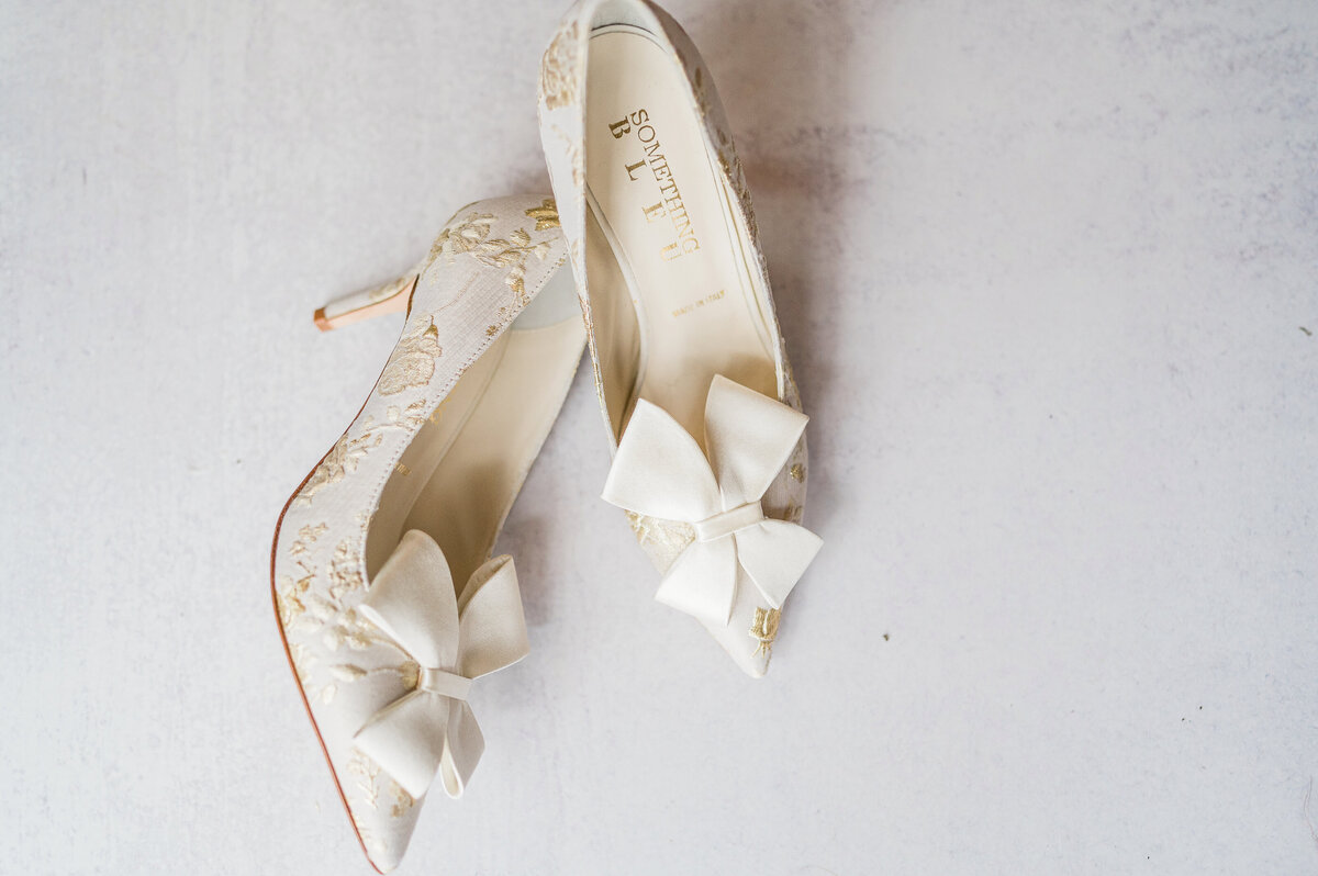 Beautiful gold and white wedding shoes.