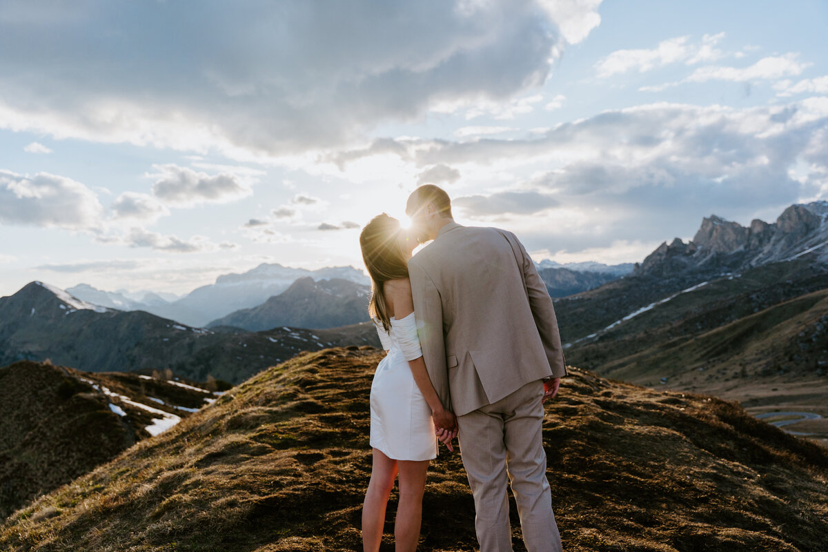 Couple standing together at sunset on alpine ridge