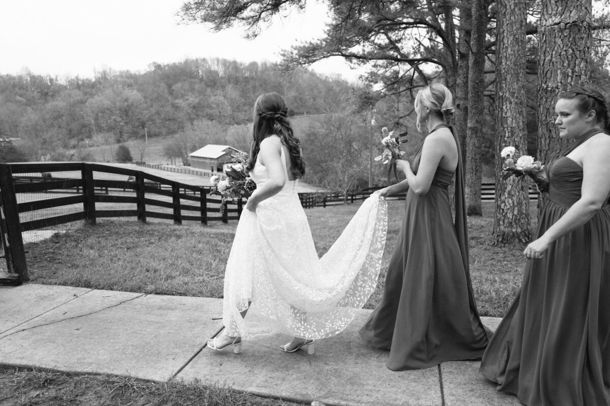 bridesmaids-carrying-brides-dress