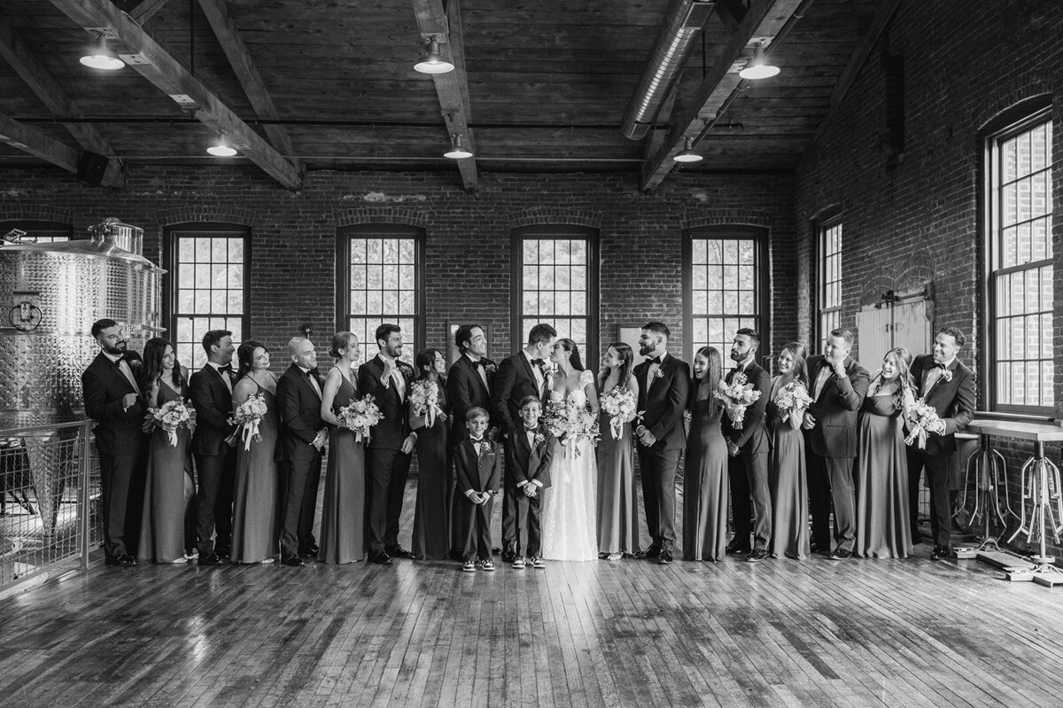 bride and groom with bridal party for indoor group picture