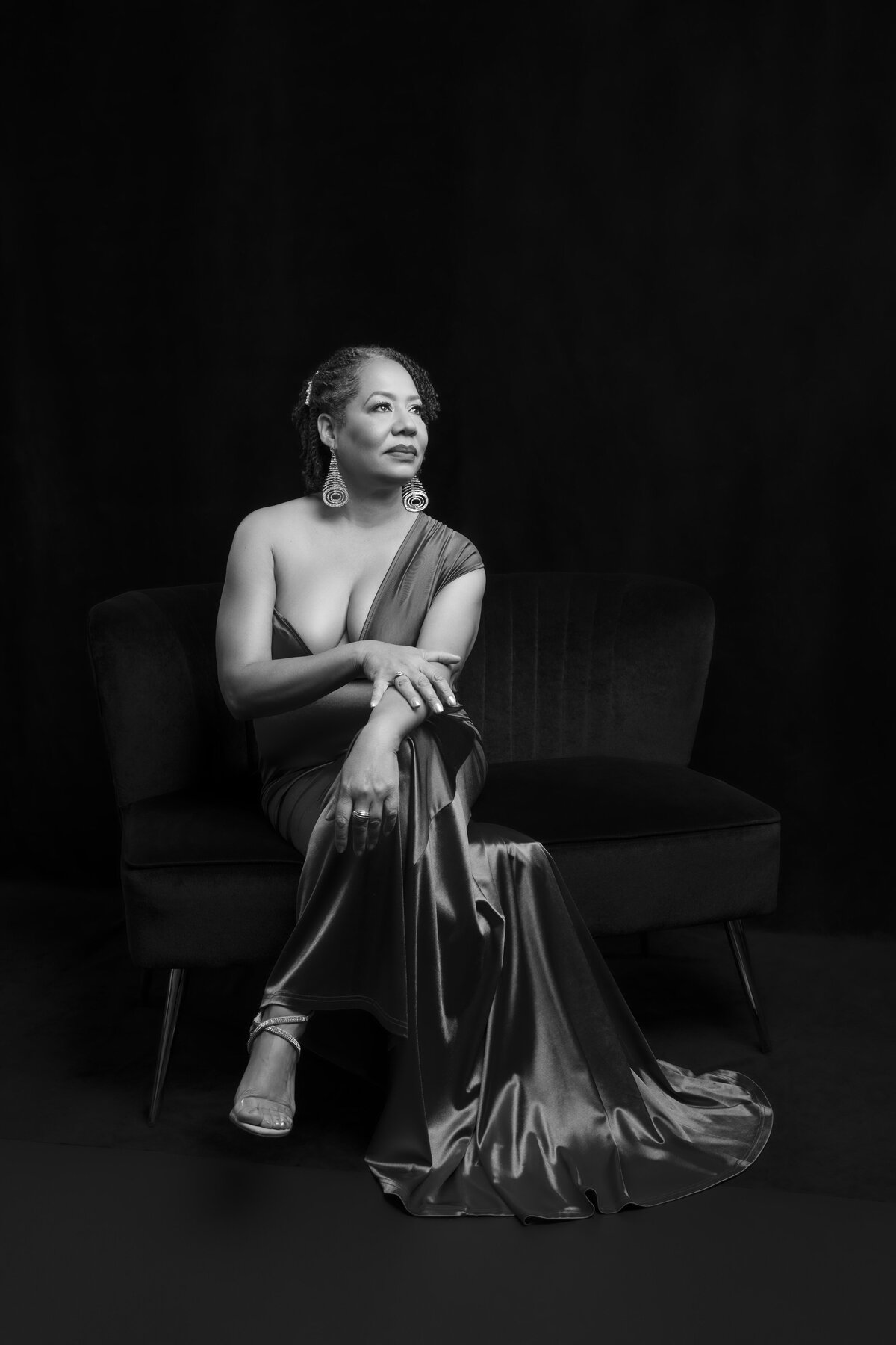 Couple poses for natural maternity photos in black-owned photography studio