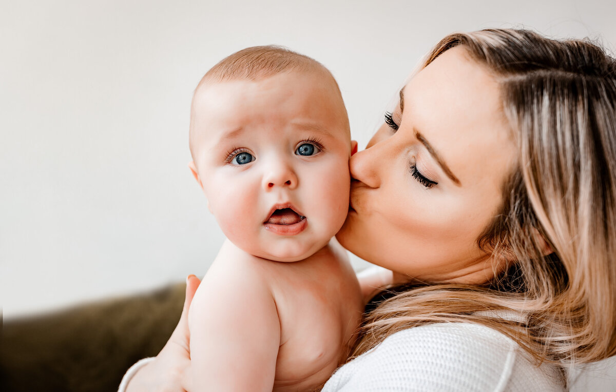 mommy kissing baby in the check at studio toledo ohio