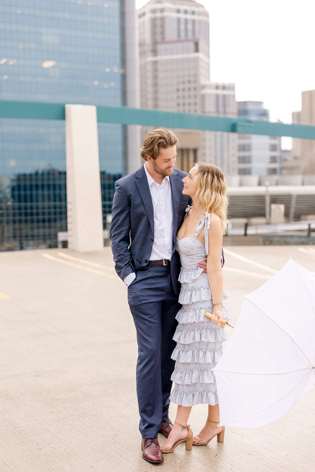 Engagement session in downtown Minneapolis features a chic couple embracing the rain