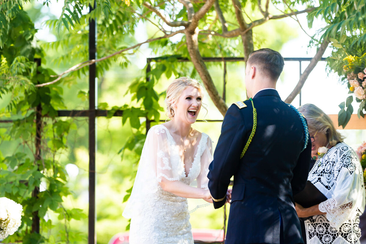 Bride and groom laughing at wedding ceremony at Fat Bottom Brewery wedding in Nashville, TN