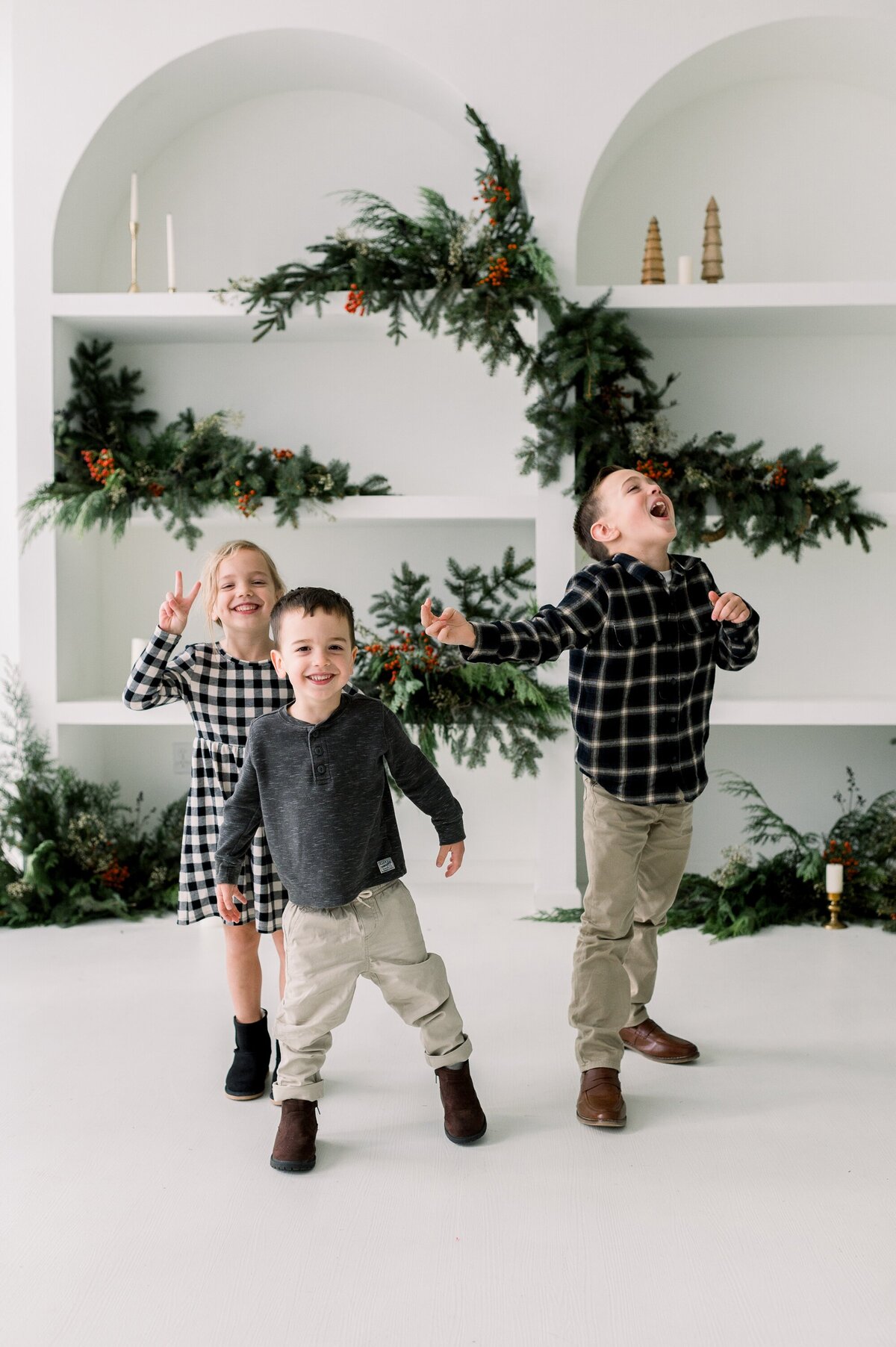 Happy kids with Christmas backdrop.