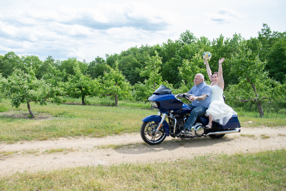 Bride and groom riding Harley at their wedding