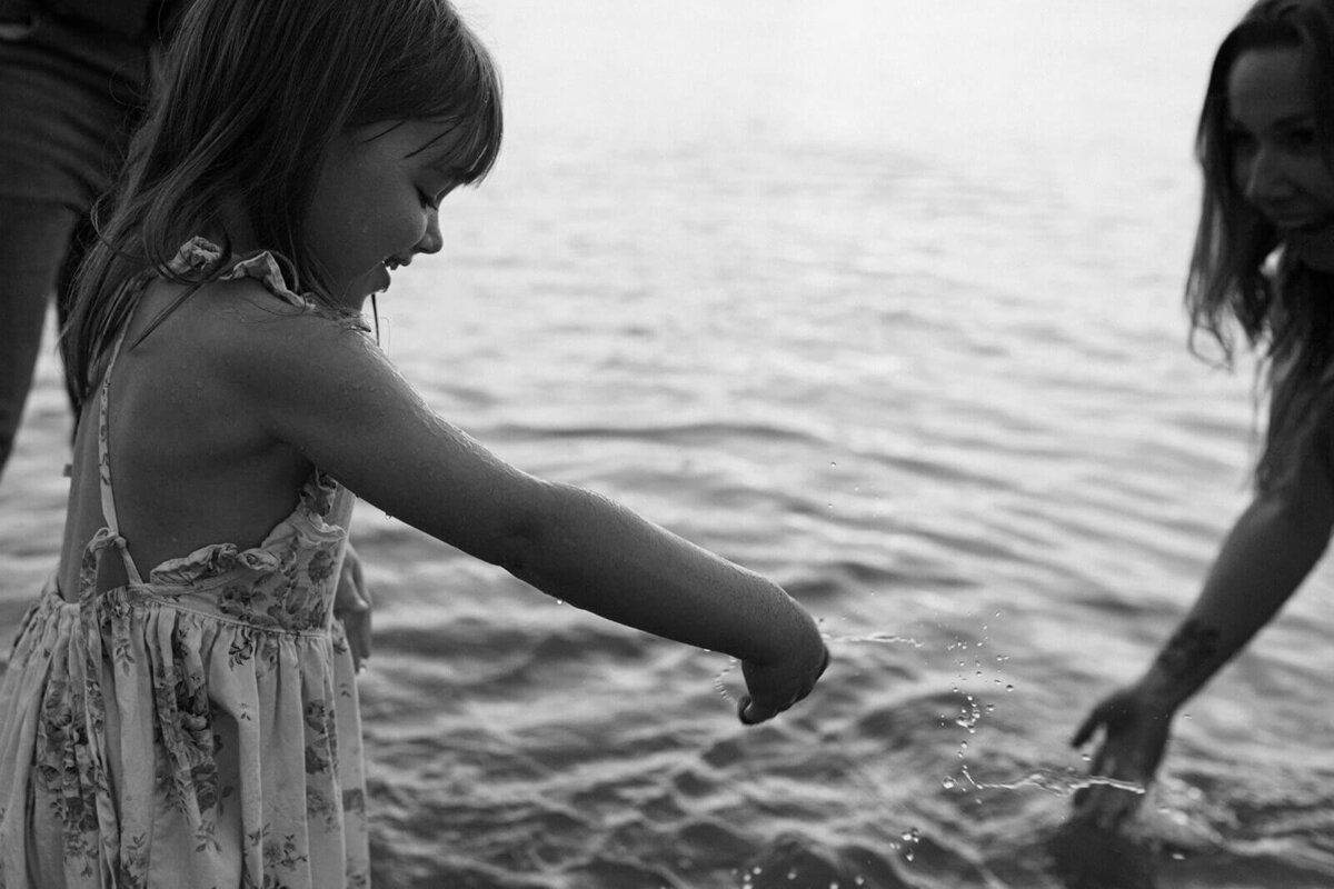 young girl playing near the water at Finger Lakes, NY