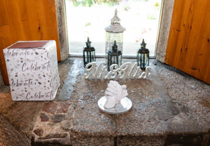 A stone windowsill with a Mr & Mrs sign and a gift