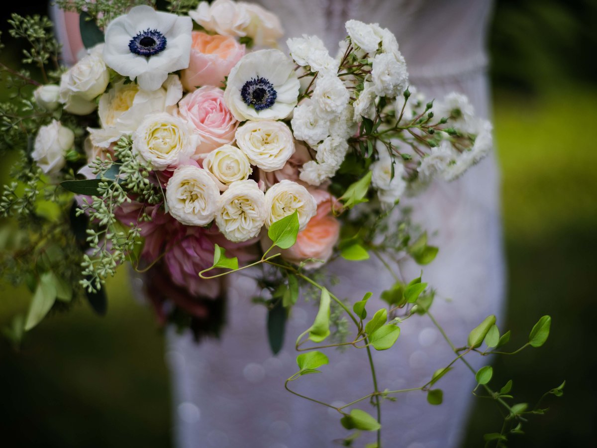 Romantic garden style wedding bouquet of roses, Juliet roses, anemone's and clematis  vines.