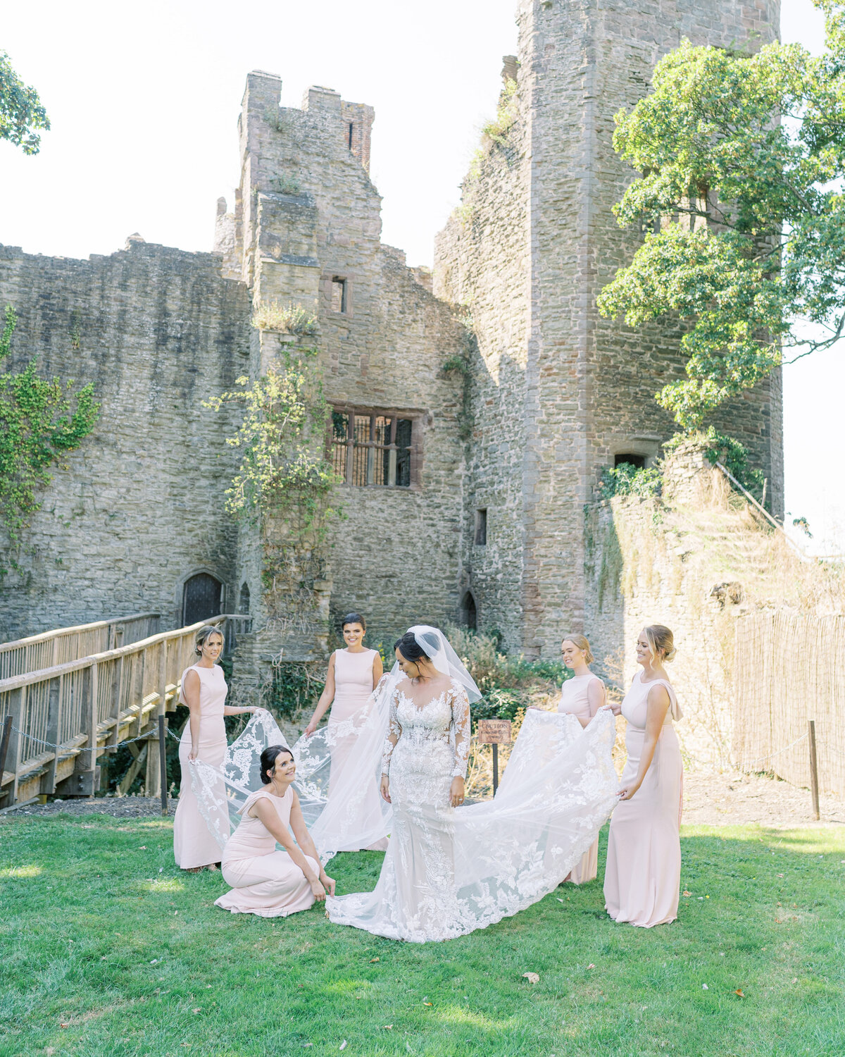 Bride and her bridesmaids at marquee wedding in an English castle