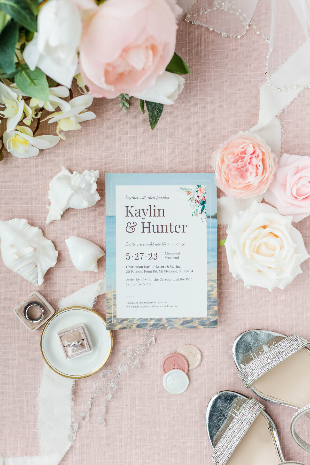 wedding invitation flatlay with pink flowers