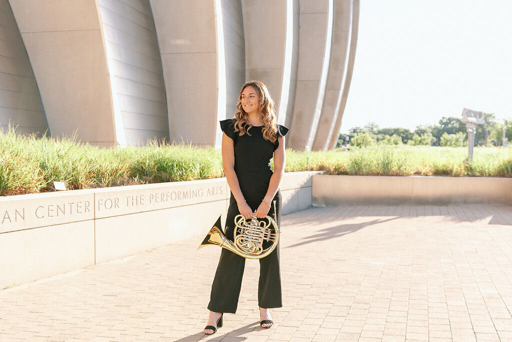 senior holds tuba for senior photos in kansas city